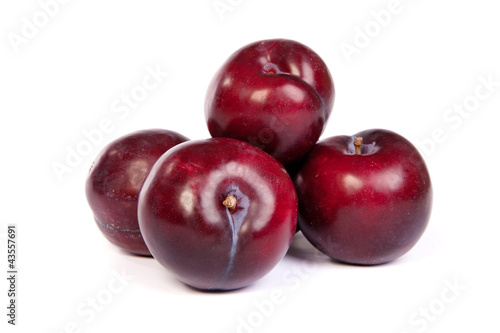 Group of plums  on white