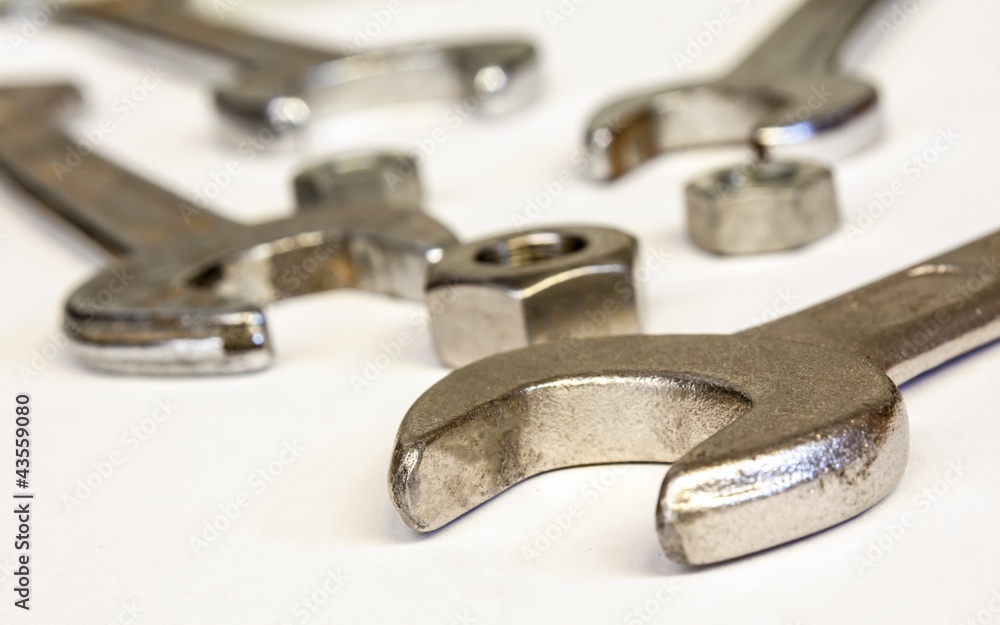 wrench compasses and nuts on white background wrench compasses and nuts on white background