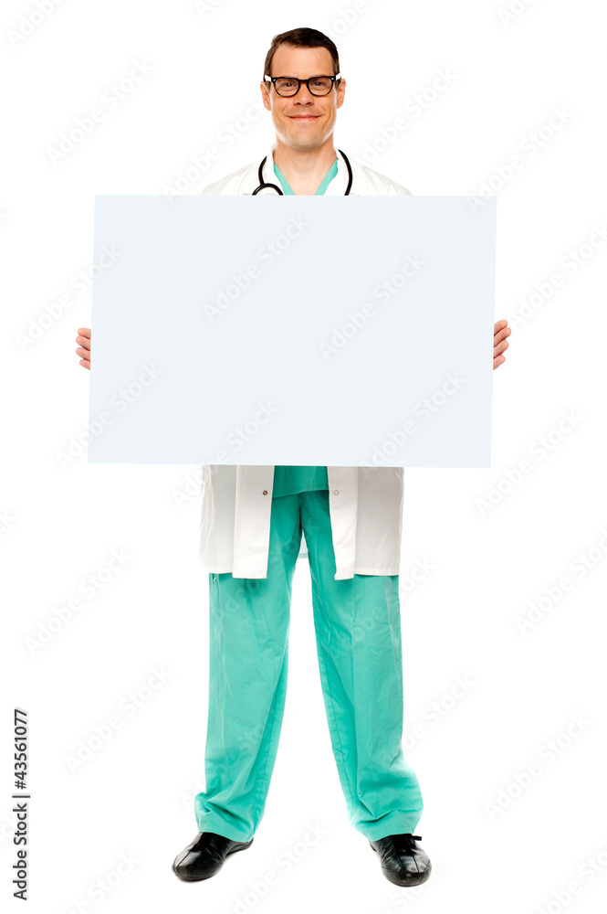 Male doctor displaying white advertising board Male doctor displaying white advertising board