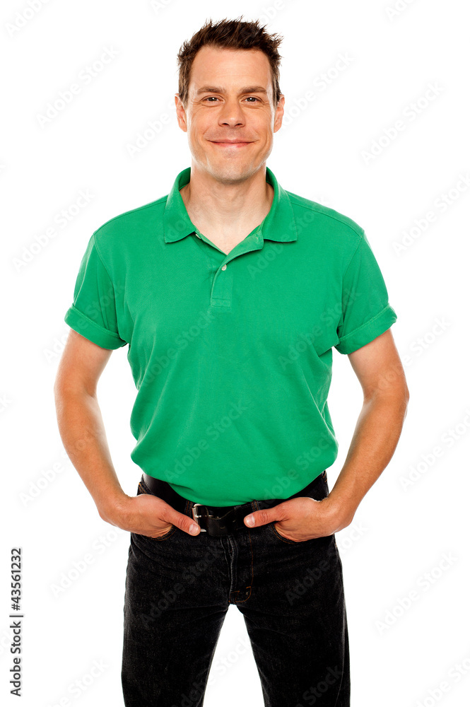 Smiling guy posing with hands in jeans pocket Smiling guy posing with hands in jeans pocket