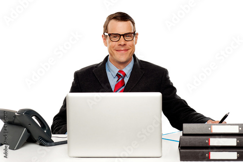 Confident smiling male executive wearing glasses