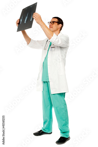 Experienced surgeon looking at patient's x-ray