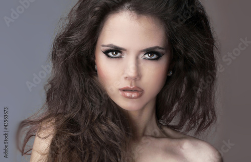 Fashion model woman brunette with curly hair