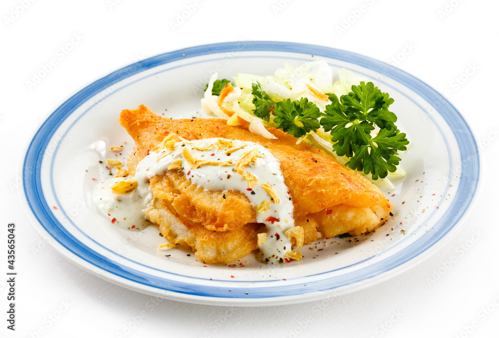 Fish dish - fried fish fillets and vegetable salad Fish dish - fried fish fillets and vegetable salad