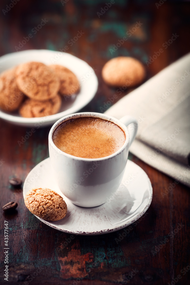 Cup of espresso and biscotti on dark wooden table Cup of espresso and biscotti on dark wooden table