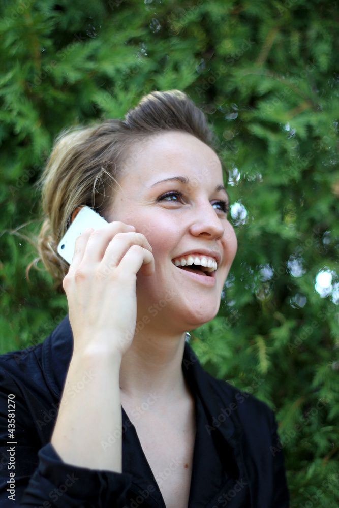 Young Attractive Businesswoman Laughing While On the Phone Young Attractive Businesswoman Laughing While On the Phone