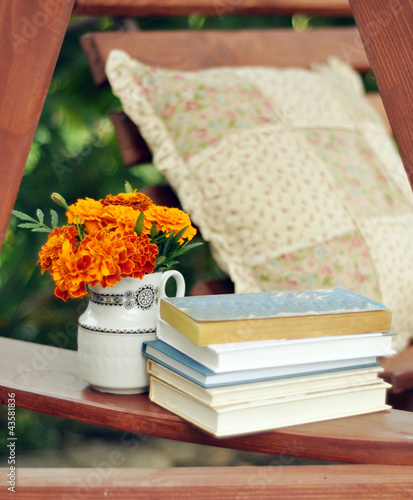 Books, and marigolds in a vase stock image