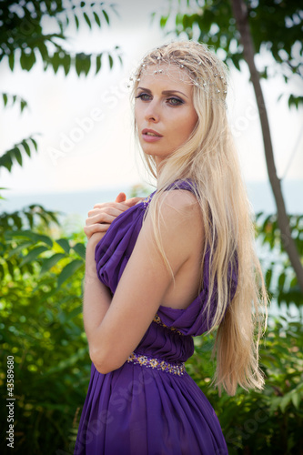 Outdoor portrait of beautiful blond woman in purple dress © rodjulian