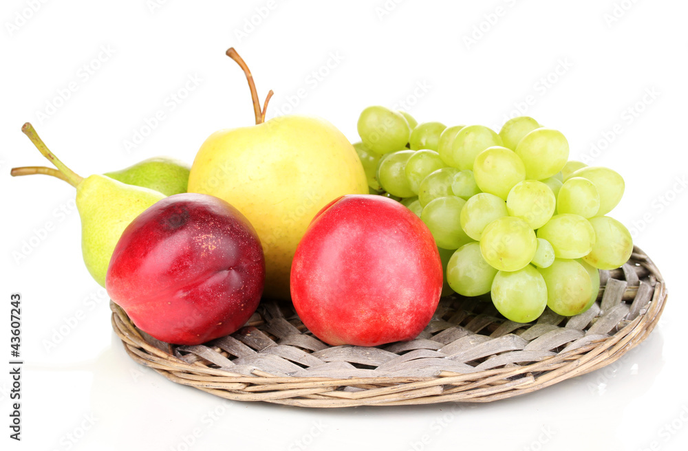 ripe sweet fruits and berries on wicker mat isolated on white ripe sweet fruits and berries on wicker mat isolated on white