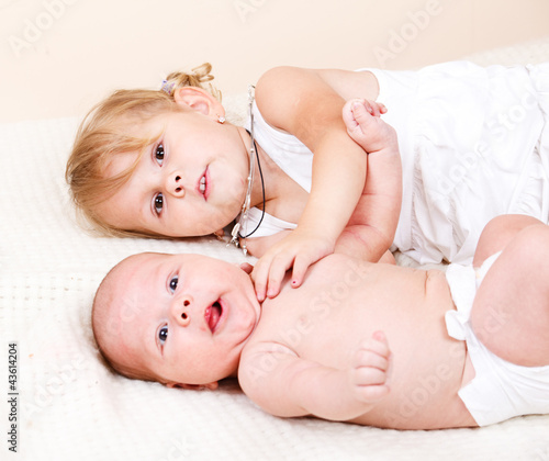 Toddler girl with newborn baby