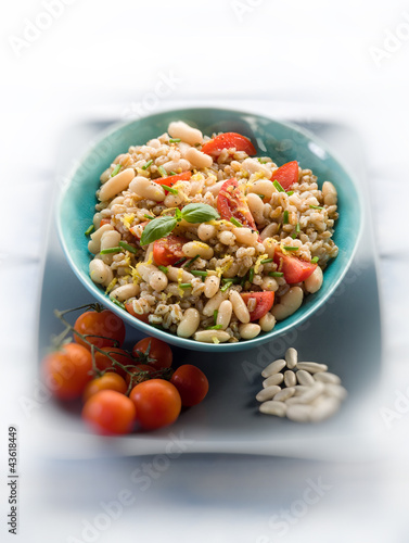 spelt risotto with beans and tomatoes, selective  focus,