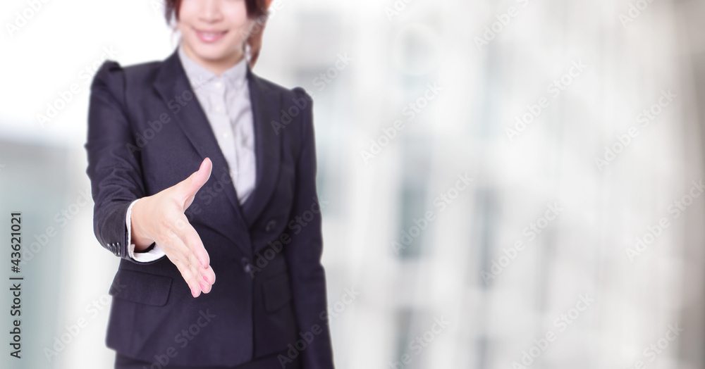 Business woman gives a handshake with smile Business woman gives a handshake with smile