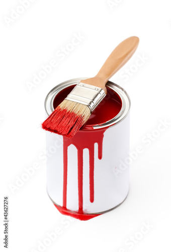 Full of red paint tin and paint brush with red ink