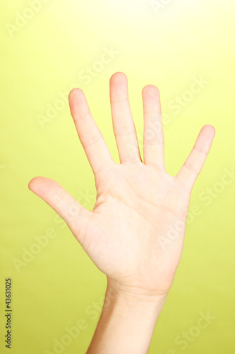 Hand making sign on green background