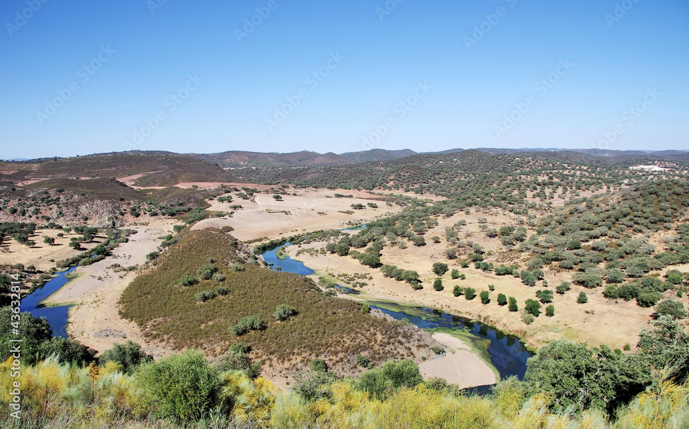 Landscape of valley and river near Barrancos, Portugal.