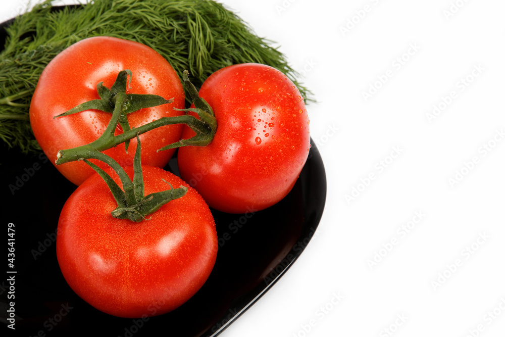 Fresh tomatoes on a plate, isolated on a white background. Fresh tomatoes on a plate, isolated on a white background.