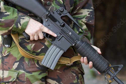 Soldier holding automatic rifle