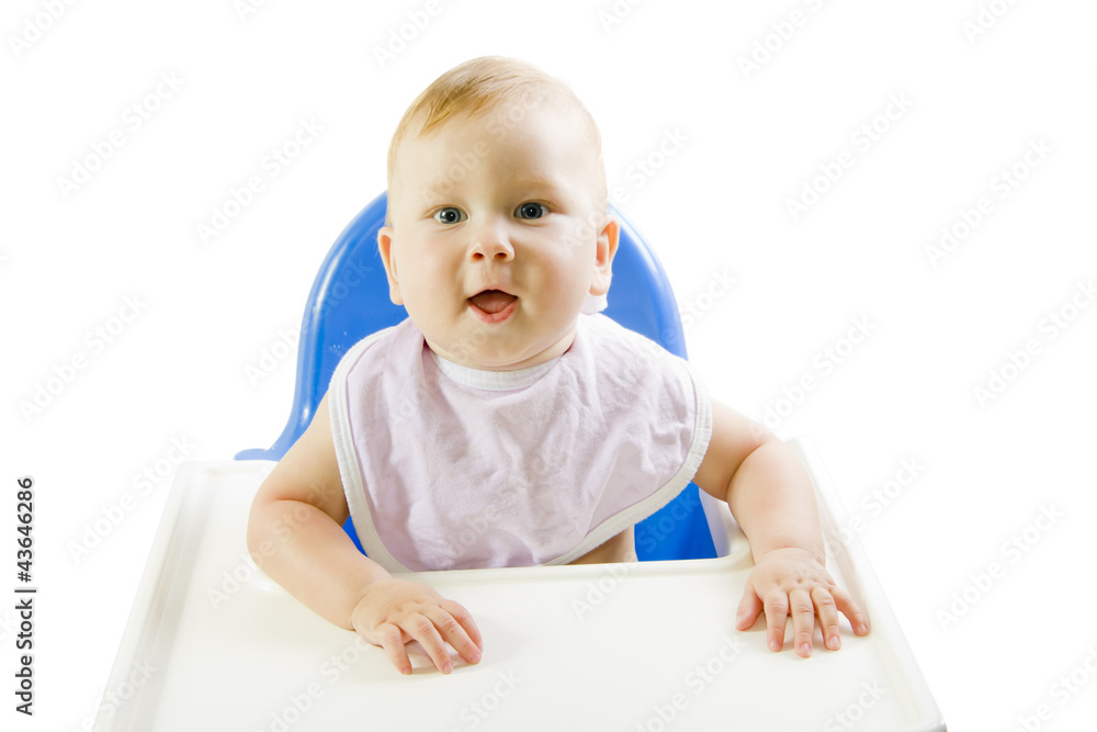 A young blue-eyed child feeding pumpkin puree A young blue-eyed child feeding pumpkin puree