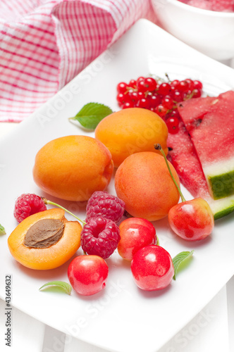 Summer fruits  watermelon  raspberries  cherries and apricots