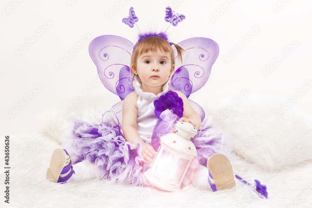 Portrait of a beautiful little girl in a lilac dress