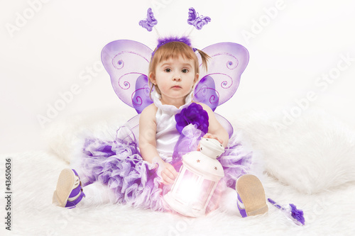 Portrait of a beautiful little girl in a lilac dress