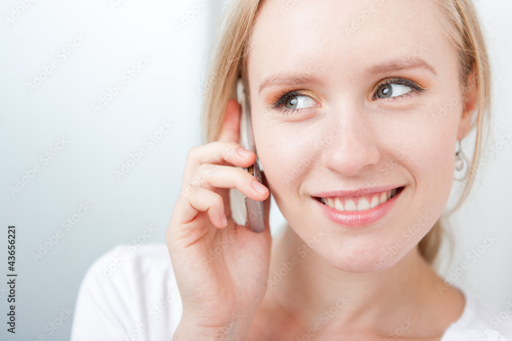 Closeup portrait of a happyblond woman speaking on a cellphone Closeup portrait of a happyblond woman speaking on a cellphone