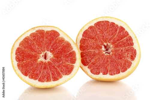 Two halves of ripe grapefruit isolated on white
