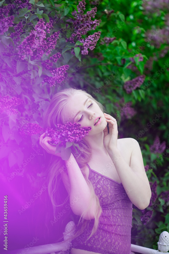 Fototapeta premium Woman with a lilac flowers.
