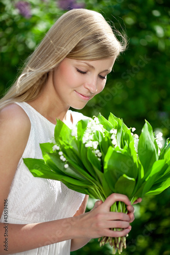 Portrait of young beautiful smiling woman outdoors