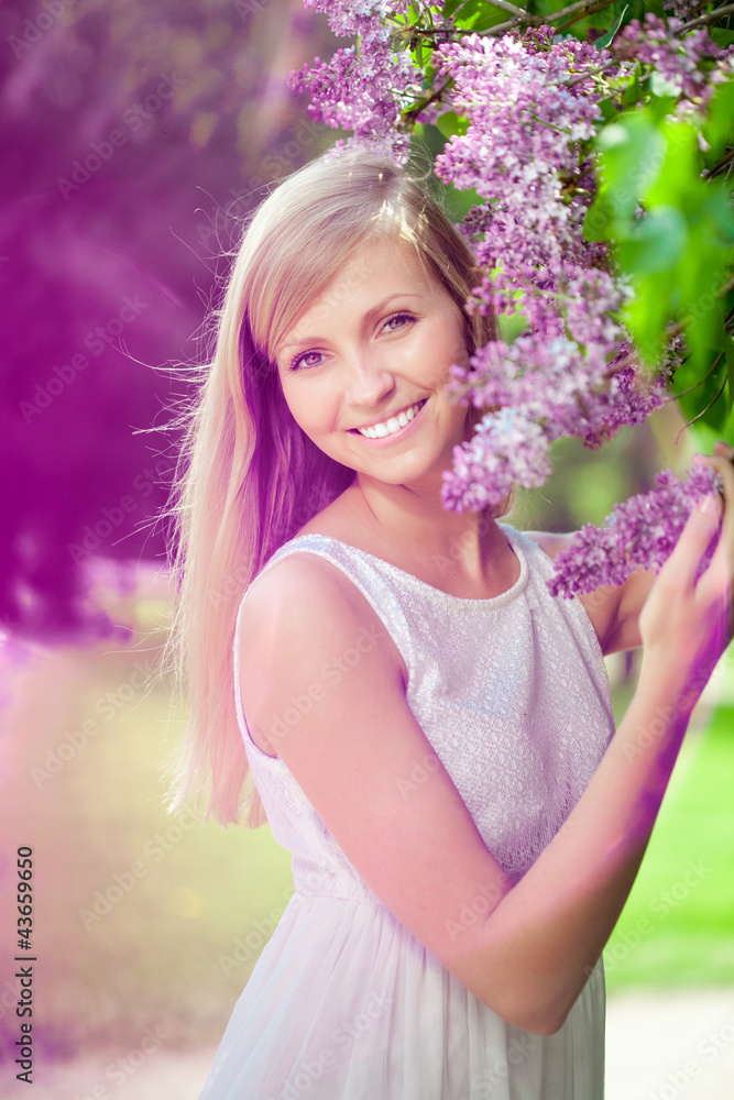 Smiling beautiful woman with violet flowers Smiling beautiful woman with violet flowers