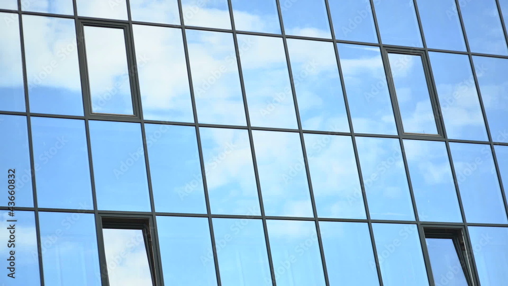 Time lapse of clouds, reflected in the windows of building Time lapse of clouds, reflected in the windows of building