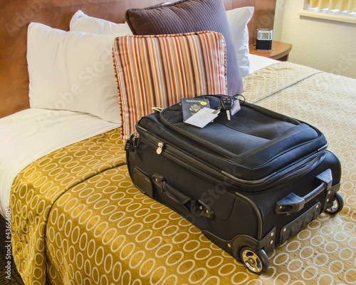 Roll Aboard Bag on a Hotel Bed