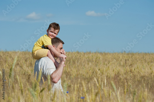 Dad and son going in the field