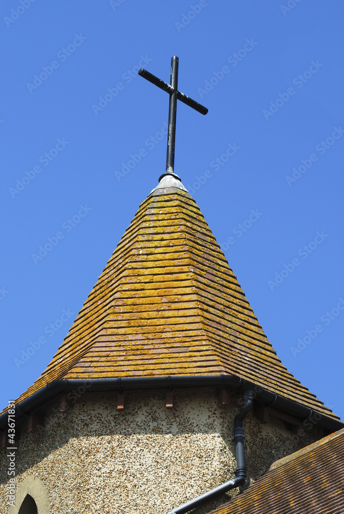 Small spire with cross on church at Shoreham. UK