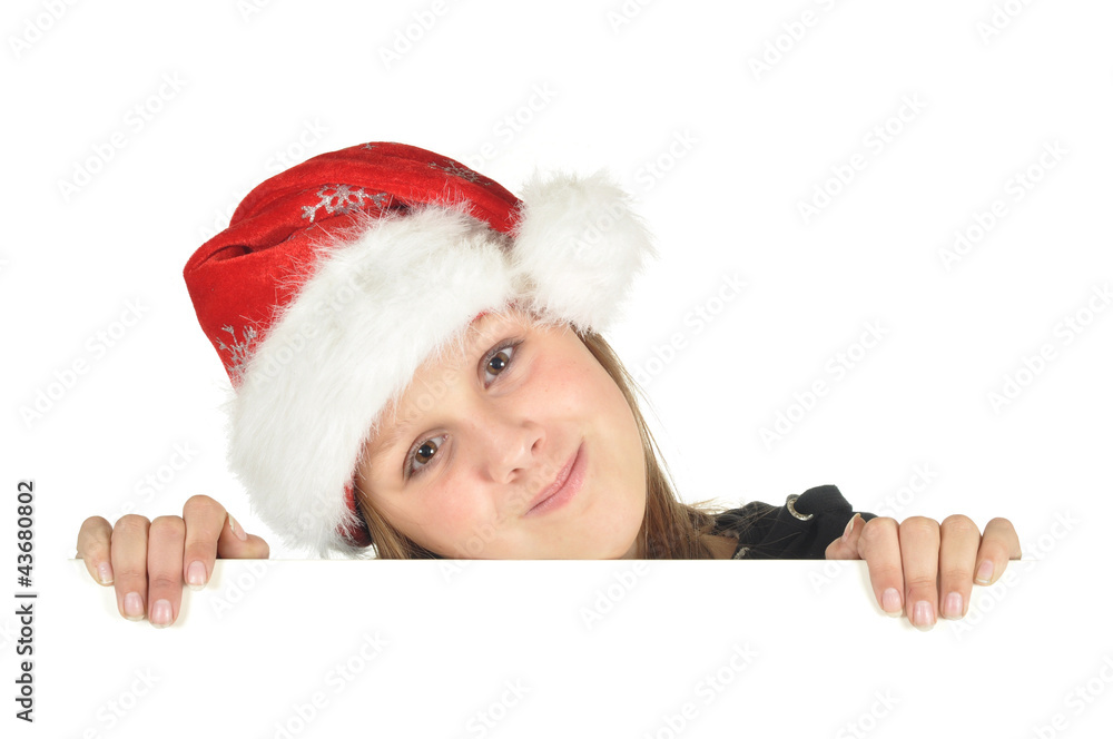 Teenage girl with Christmas hat looks over the edge (isolated) Teenage girl with Christmas hat looks over the edge (isolated)