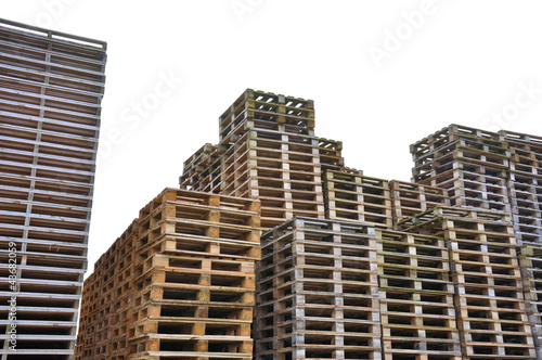 Piles of empty wooden pallets with white background