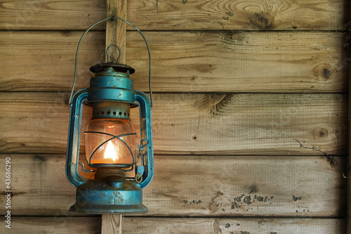Rusty lantern hanging in a shed photo