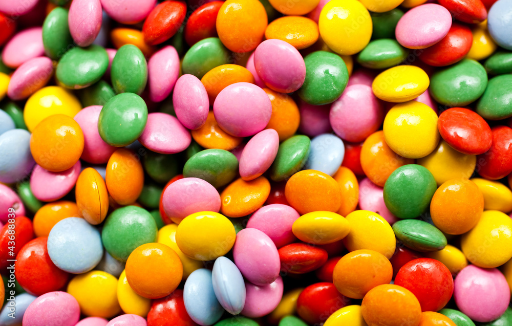Background image of sweet candies or chocolate buttons Background image of sweet candies or chocolate buttons