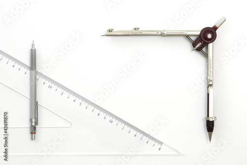 Aluminum pencil, drawing compass and ruler on white background