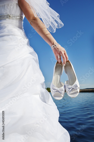 bride with wedding shoes photo