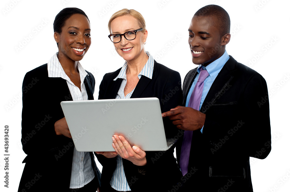 Team of friendly business people using laptop Team of friendly business people using laptop