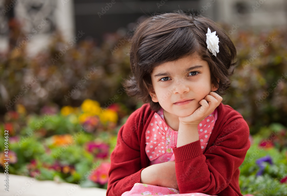 Angry and Thoughtful Caucasian Little girl in the Garden Angry and Thoughtful Caucasian Little girl in the Garden