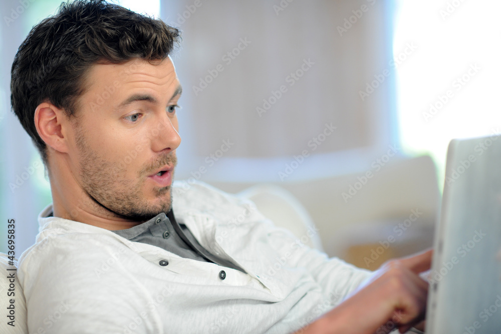 Man in sofa using electronic tablet Man in sofa using electronic tablet