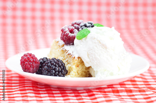 cake with icing icecream  raspberry  blackberry and mint on a pl