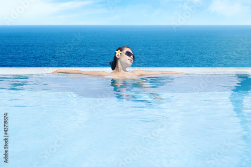 Woman enjoying infinity pool 1 © Creativa Images