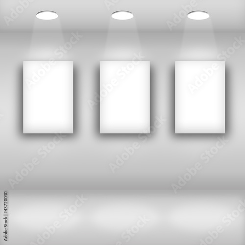 Empty frames on bright wall in gallery interior © Rafal Olechowski