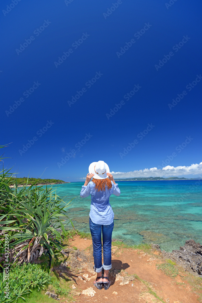 南国沖縄の海辺で寛ぐ女性