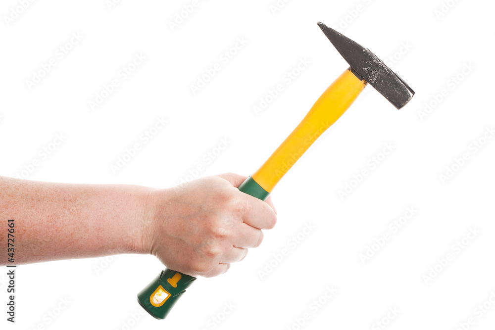 Female hand holding a hammer Female hand holding a hammer