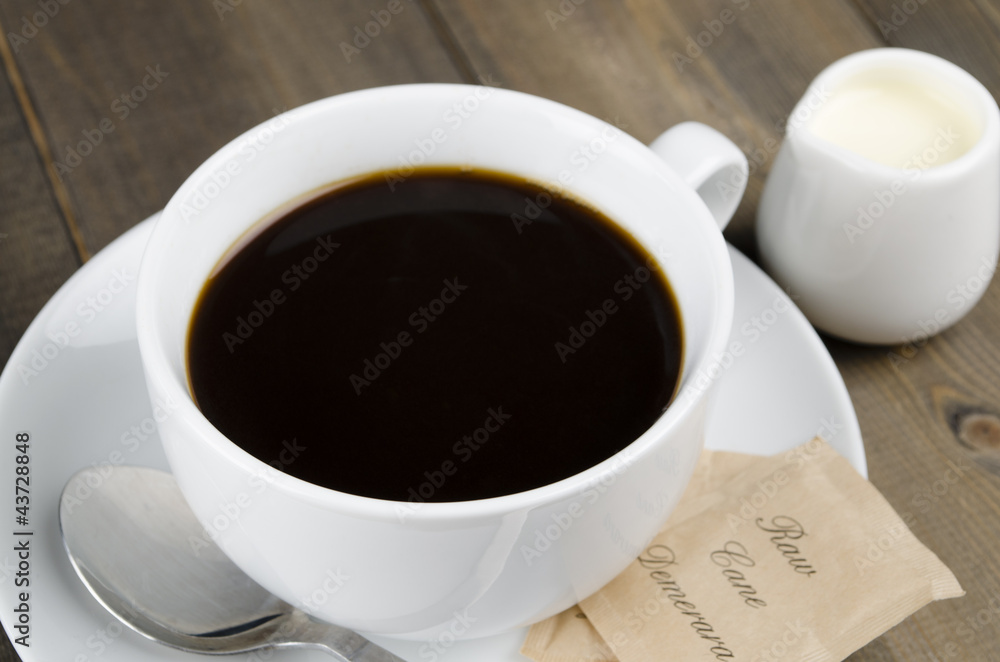 Americano black coffee, demerara sugar sachets & a jug of milk Americano black coffee, demerara sugar sachets & a jug of milk
