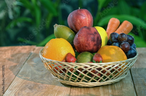 A basket of fresh fruit  pictures under a warm morning light